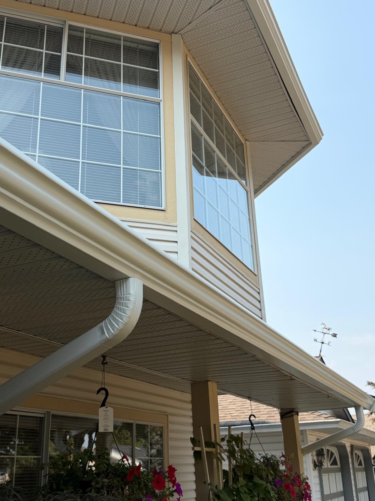 Home with white gutters and paneled porch